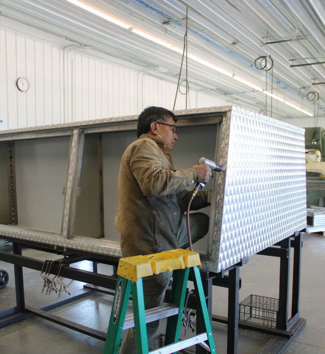 Amish craftsman building a custom aluminum truck cap in the Sugarcreek, Ohio shop